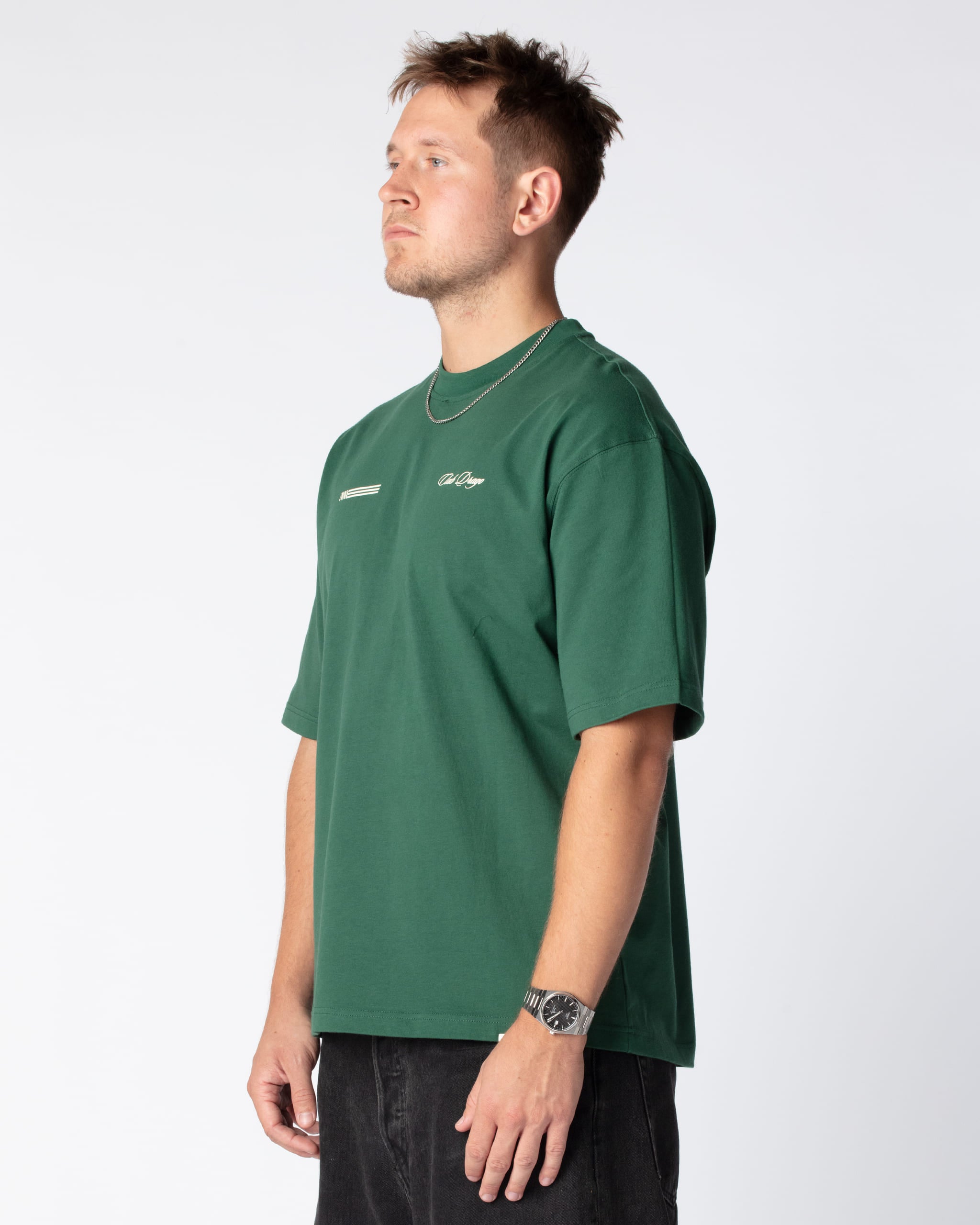 Diagonal shot of Mathias in our Green Racing Team T-Shirt with dual front screenprint